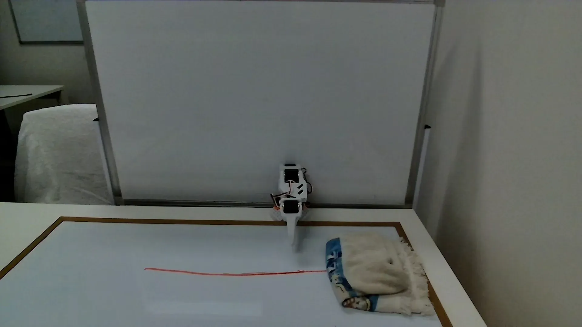 Top camera view of the Erase Whiteboard workspace showing board and robot approach zone.